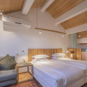 Postel nebo postele na pokoji v ubytování Hangzhou Shange Hotel