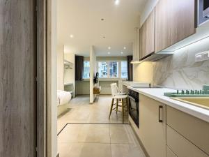 a kitchen with a sink and a counter top at Palama Urban Vibes by ProLiving Hospitality in Thessaloniki