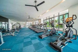 a gym with a row of treadms and cardio machines at R&F Princess Cove 2BR, JB CIQ, Shopping Malls, by Good Life Homestay in Johor Bahru