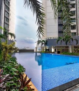 a large swimming pool in the middle of a building at R&F Princess Cove 2BR, JB CIQ, Shopping Malls, by Good Life Homestay in Johor Bahru
