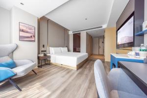a hotel room with a bed and a desk at Atour Hotel Zhuhai Qinglu South Road Gongbei Port in Zhuhai