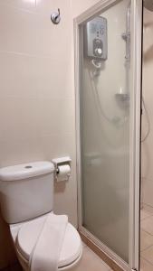 a bathroom with a toilet and a shower at 103 Hotel in Kuala Lumpur