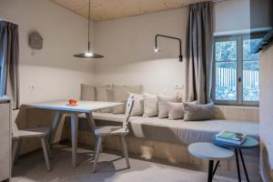 a bedroom with a bed and a table and chairs at Ansitz Pontegardena in Ponte Gardena