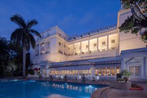 a hotel with a swimming pool in front of a building at ITC Windsor, a Luxury Collection Hotel, Bengaluru in Bengaluru
