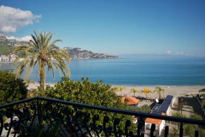 a view of the beach from a balcony at ORAMA apartment Front sea in Giardini Naxos