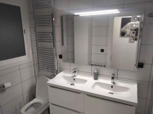 a white bathroom with a sink and a toilet at San Nicolas by clabao in Pamplona