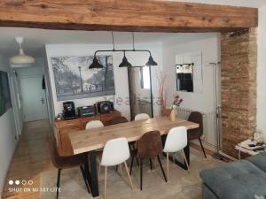 a dining room with a wooden table and chairs at San Nicolas by clabao in Pamplona