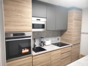a kitchen with a sink and a stove at San Nicolas by clabao in Pamplona