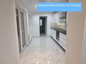 a kitchen with white cabinets and a tiled floor at Portobello City Centre Dublin 8 Sleep 5 in Dublin