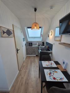 TV a/nebo společenská místnost v ubytování Appartement des dunes à 200m de la plage