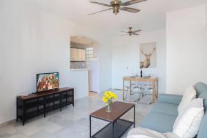 a living room with a couch and a tv at Cozy Apartment With Terrace in Mijas