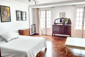 a bedroom with a bed and a dresser in it at Spacious house with terrace and balcony in A Coruña in A Coruña