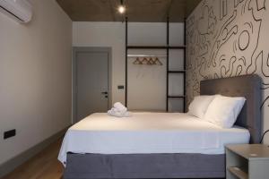 Postel nebo postele na pokoji v ubytování RudBlu Suites