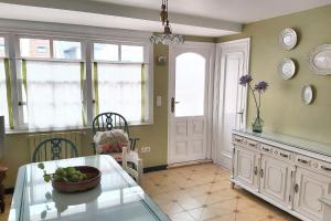 a kitchen with a table with a bowl of fruit on it at Spacious house with terrace and balcony in A Coruña in A Coruña