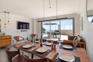 a dining room with a table and chairs and a room with a view at Seaview 3-bed Flat With 2 Terraces Mijas Pueblo in Mijas