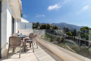 a patio with a table and chairs on a balcony at Seaview 3-bed Flat With 2 Terraces Mijas Pueblo in Mijas