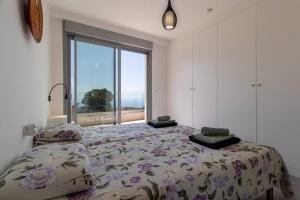 a bedroom with a bed and a large window at Seaview 3-bed Flat With 2 Terraces Mijas Pueblo in Mijas +49 photos