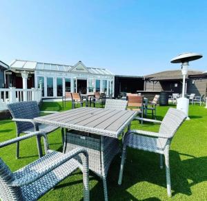 a picnic table and chairs in a yard at 6 Berth Caravan with garden - Brightholme Holiday Park in Brean