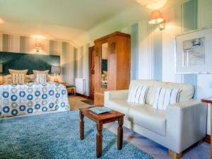a living room with a couch and a bed at Stables Studio in Bedford