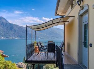 a balcony with a view of the water at Luxury Residence La Pianca - Pool and Terrace Lake View in Musso