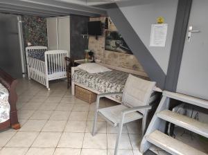a small bedroom with a bed and a chair at Maison sur le causse du Quercy Lot 46 in Cremps +15 photos