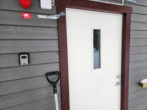 a white door on a house with a garage at Vemdalen Base Camp in Vemdalen