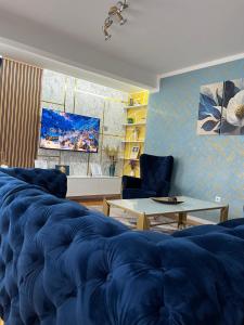a living room with a blue bed and a table at BLUE MOON in Sarajevo