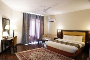 Ένα ή περισσότερα κρεβάτια σε δωμάτιο στο Hunza Darbar Hotel