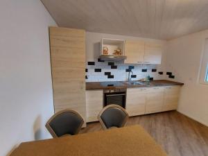 a kitchen with a table and chairs in a room at good bed wynau in Wynau
