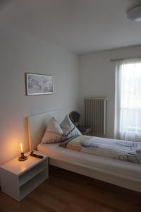 a bedroom with a bed and a candle on a table at good bed wynau in Wynau