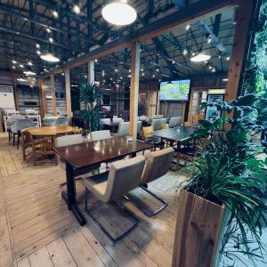 a dining room with a table and chairs at NTV Smoky Garden in Owariasahi