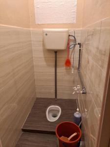 a small bathroom with a toilet in a stall at Homestay Hajah Jamilah Sungai Tiram in Ulu Tiram +11 photos