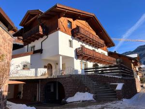 a building with wooden balconies and stairs on it at Scurcia in Ortisei