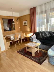 a living room with a couch and a table at Scurcia in Ortisei
