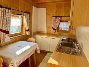 a small kitchen with a table and a sink at Scurcia in Ortisei +29 photos
