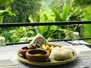 a tray of food sitting on a table at Rainforest Mask villa in Deniyaya