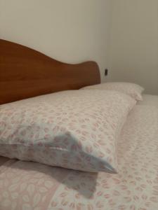 a pillow sitting on top of a bed at Franca’s dream - Bellagio in Bellagio
