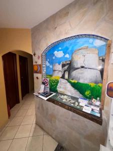 a wall with a painting on it in a room at Le Soleil B&B in Milazzo