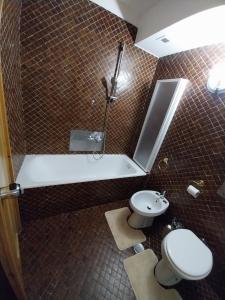 a bathroom with a shower and a toilet and a sink at Casa Cornella cir226 in Pila +18 photos