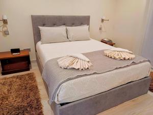 a bed with two pillows on it in a bedroom at Cabo da Vila Guesthouse in Ribeira Grande +56 photos