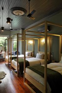 a bedroom with three beds in a room at The Black House in Robertson