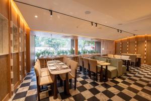 Un restaurante con mesas y sillas y suelo de cuadros. en Ramee Collextion Amritsar, en Amritsar 51 fotos más