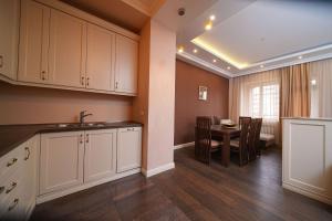 a kitchen with a sink and a table in a room at Mount Ararat view 2-bedroom Luxury Apartment by Sweet Home in Yerevan