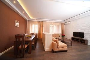 a living room with a dining table and a television at Mount Ararat view 2-bedroom Luxury Apartment by Sweet Home in Yerevan
