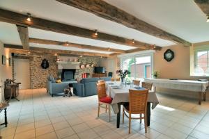 a living room with a table and a couch at Le Petit Porcon in Saint-Méloir-des-Ondes