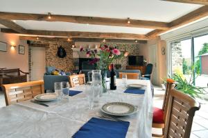 a dining table with a white table cloth and blue napkins at Le Petit Porcon in Saint-Méloir-des-Ondes +11 photos