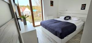 Ένα ή περισσότερα κρεβάτια σε δωμάτιο στο TriAapart Apartamenty ZŁOTY BRZEG Mikoszewo