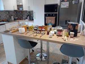 a kitchen counter with a table with food on it at La Bergerie de Chantemille - Chambre d'hôtes familiale les Dahlias - jacuzzi, piscine in Ahun