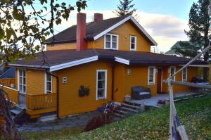 una casa gialla con il tetto nero di Villa Borealis a Trondalen