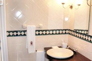 a bathroom with a sink and a toilet at Welcoming house in Souto da Casa - 50 m² with enclosed garden in Souto da Casa +24 photos